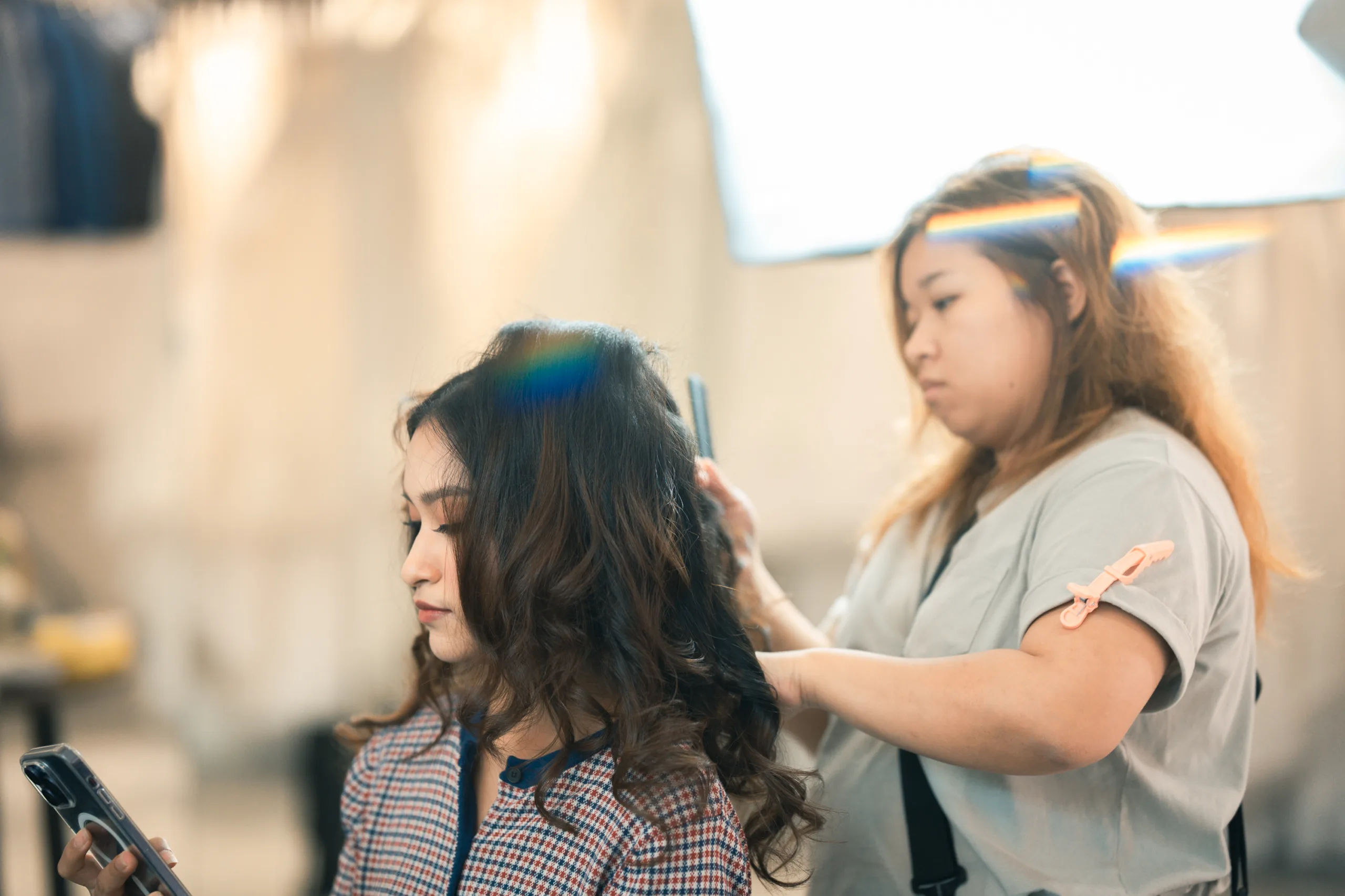 Behind the scenes of a bridal photoshoot. Aoi's Makeup is curling and styling the model's hair.